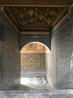 an archway in the middle of a building with tile work on it's walls