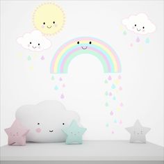 a white shelf topped with stars and rainbow wall decals