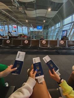 three people are holding their passport in the airport