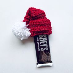 a candy bar with a red knitted hat on top