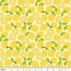 a yellow background with lemons and green leaves on it, as well as a ruler