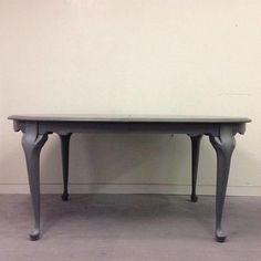 a gray table sitting on top of a cement floor