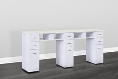 a white desk with three drawers in an empty room