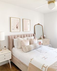 a bedroom with a bed, dresser and mirror on the wall next to each other