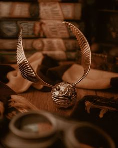 a metal object sitting on top of a wooden table next to scissors and other items