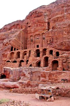 an ancient building carved into the side of a mountain