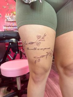 a woman's thigh with the words, love is all you need written on it