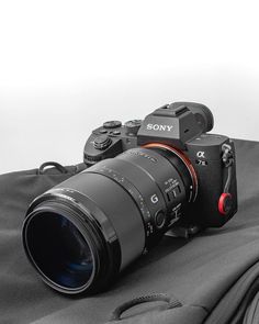 a camera sitting on top of a black bag