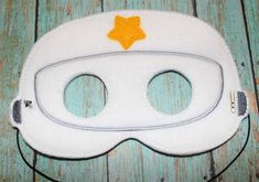 a white mask with yellow stars on it