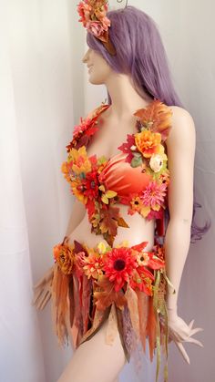 a mannequin with flowers and leaves on it's body