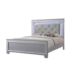 a bed with an upholstered headboard and foot board is shown in grey