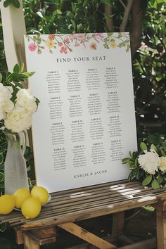 a seating chart with flowers and lemons on a bench