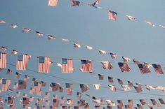 many american flags are hanging from a line