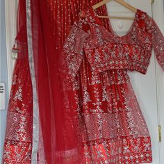 Beautiful Red Color Heavy Netted Sequence Work Lehenga Choli. Lehenga Comes With Lining And Cancan.And Heavy Beautiful Tassels. Blouse Has 3/4 Sleeves.And Back Buttons. Bust Size-36” To 38”( Extra 2” Margin) Lehenga Length-39” Heavy Netted Dupatta. Perfect For Weddings. Picture For Reference. Celebration Red Sharara With Cutdana, Festive Red Cutdana Sets, Elegant Red Sharara With Dori Work, Festive Red Sets With Resham Embroidery, Festive Red Sets With Dori Work, Red Sharara For Festive Occasions With Traditional Drape, Festive Red Set With Dori Work, Red Cutdana Choli For Party, Festive Red Sharara With Traditional Drape