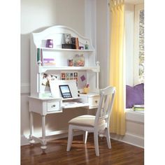 a white desk with a laptop computer on top of it next to a chair and window