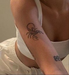 a woman with a crab tattoo on her arm