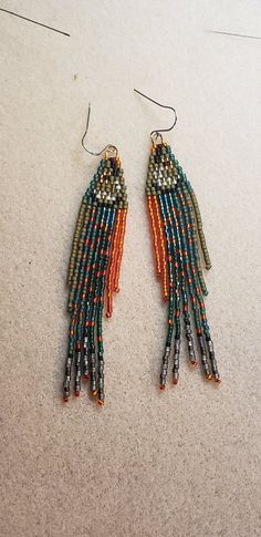 two pairs of beaded earrings on the floor