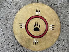 a frisbee with an animal's paw on it sitting on the ground