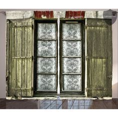 an open window with wooden shutters on a white brick wall and patterned glass panels