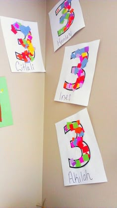 the wall is decorated with colorful paper and cut out numbers for children's names