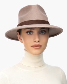 The versatile hand-blocked wool felt fedora banded with lamb leather is water-repellent. The Crown is fully lined. The elasticized inner band fits most. Packable. Made in the USA of imported materials. Sustainable wool is shorn and milled from multi-use sheep living on small farms under the most humane conditions. Designed and finished in USA Hand-blocked by skilled artisans Highest Quality Materials Sustainable wool Brim Span: 3"(7.6cm) Winter Fedora, Borsalino Hats, Small Leather Accessories, Brimless Hat, Small Farms, Women Hats, Wool Fedora, Felt Fedora, Band Fits