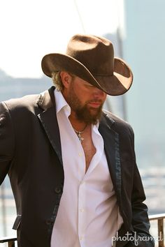 a man with a beard wearing a cowboy hat