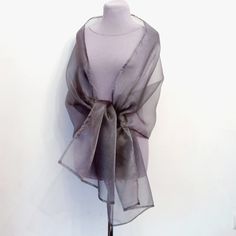 Gorgeous large organza shawl. The bolero is gray with a beautiful silver shine. Made from high quality organza. Can be used as an addition to a wedding dress, for bridesmaids. Will gently cover your shoulders on a summer evening or spring. Length 230 cm Width 52 cm Color reproduction may vary depending on monitor settings. Due to the sensitive nature of the veiled item, this is a final sale and cannot be returned, but if you have any questions please contact me and I will be sure to resolve the issues. Elegant Organza Silk Scarf For Wedding, Elegant Gray Shawl For Winter, Shawls And Wraps Silver, Silver Formal Shawl, Formal Organza Shawl, Elegant Organza Shawl For Evening, Shawl Weddimg White Silk Organza, Elegant Sheer Organza Veil, Shawl Weddimg White Silk Organza Shoulder