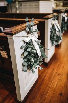 wreaths are tied to the back of pews