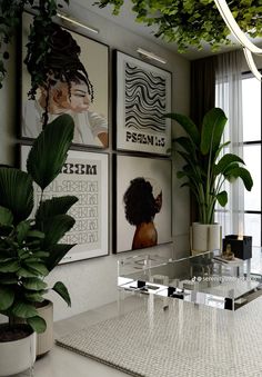 a living room filled with lots of plants and pictures on the wall next to a coffee table