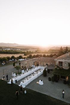 an aerial view of a wedding reception at sunset