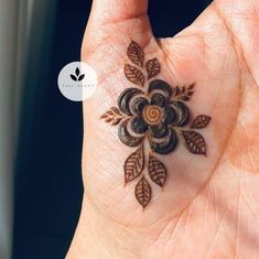 a person's hand with a small tattoo on it