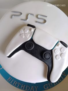 a birthday cake with a video game controller on it's side and the words ps5 written in white frosting