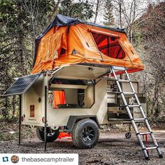 an off - road camper parked in the woods with its ladder up to it's roof