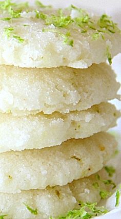 a stack of shortbreads with green sprinkles on top in a white plate