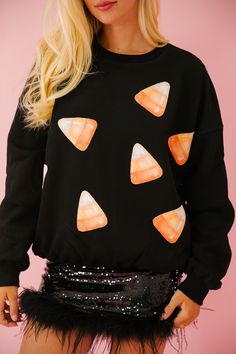 Get cozy and sweet this season with our CANDY CORN PATCH BLACK PULLOVER! This black pullover features playful candy corn patches for a touch of whimsy. Perfect for Halloween or anyone with a sweet tooth. (Warning: may induce cravings for sugary treats!) All orders are currently shipping within 14 business days. To receive item quicker, expedited shipping is available at checkout. **ALL HALLOWEEN ORDERS MUST BE PLACED WITH EXPEDITED SHIPPING TO GUARANTEE DELIVERY BY OCT. 31 IF PLACED AFTER OCT. 1 Sugary Treats, Sweater Pumpkins, Winter Decoration, Baby Graphic Tees, Shirt Y2k, Black Pullover, Oversized Long Sleeve, Women Halloween, Mini Dresses For Women