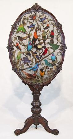 an ornate wooden stand with birds painted on it