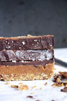 two pieces of chocolate peanut butter bars stacked on top of each other