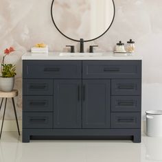 a bathroom vanity with a round mirror above it