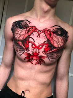 a man's chest with two crabs on it and red flowers in the middle