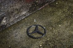 a mercedes emblem is shown on the ground