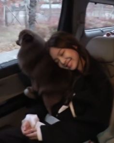 a woman sitting in the back seat of a car