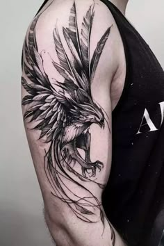 a man wearing a black and white tattoo with an eagle on his arm