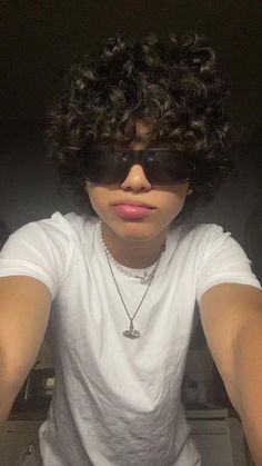 a person wearing sunglasses and a white shirt