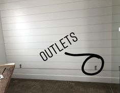 an office with a sign that says outlets on the wall next to a desk