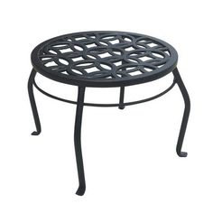 a black metal table with an intricate design on the top and bottom, against a white background