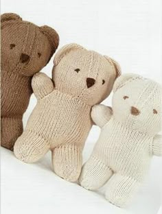 three knitted teddy bears sitting next to each other