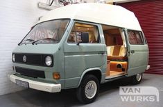 an old van is parked in a garage