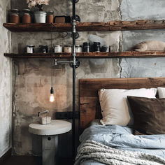 a bed sitting next to a wooden shelf filled with pots and containers on top of it