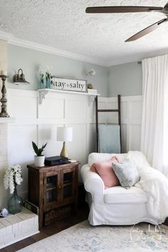 a living room with a white couch and fireplace