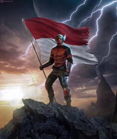 a man holding a flag standing on top of a rock in front of a storm